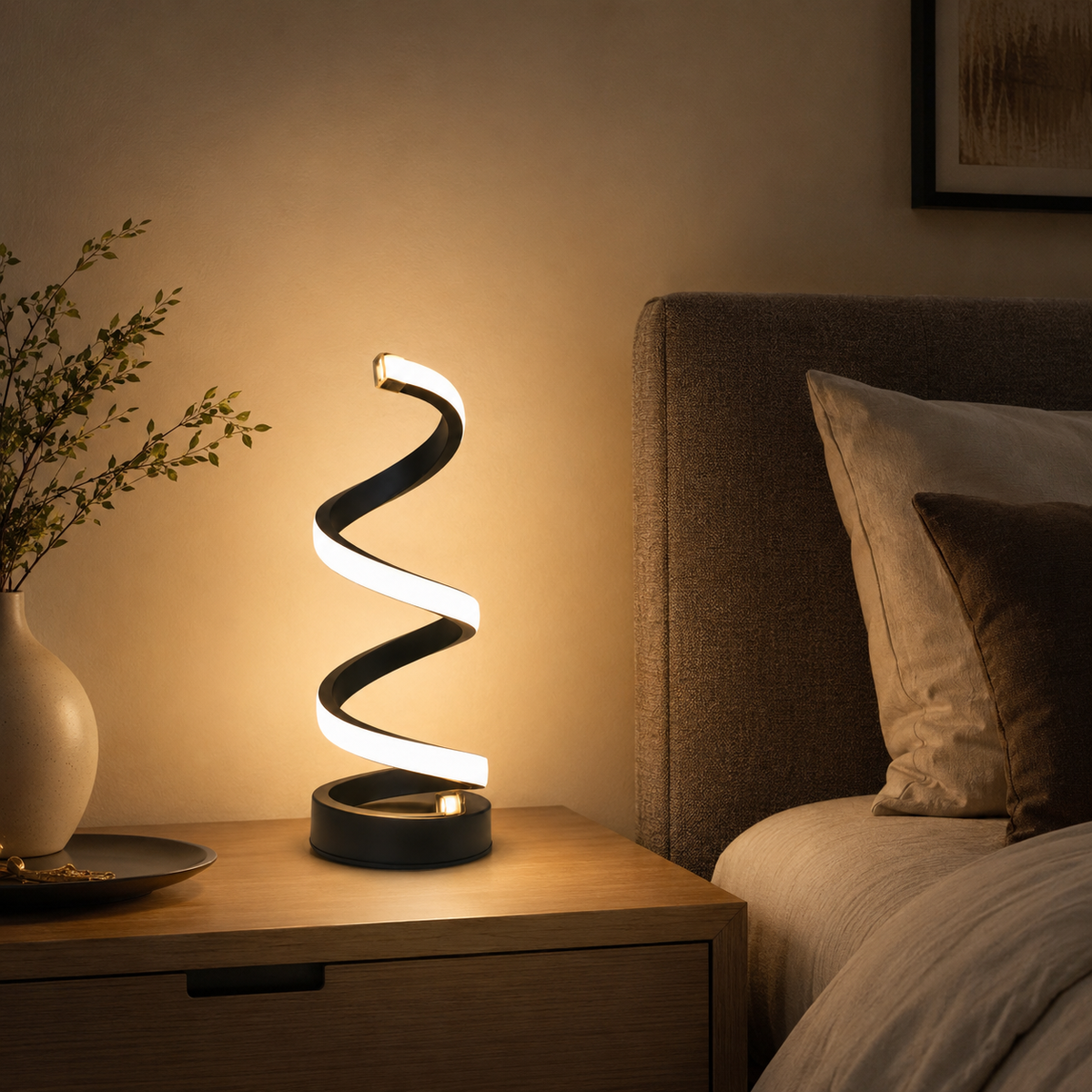 Helix Table Lamp lit on a bedside table