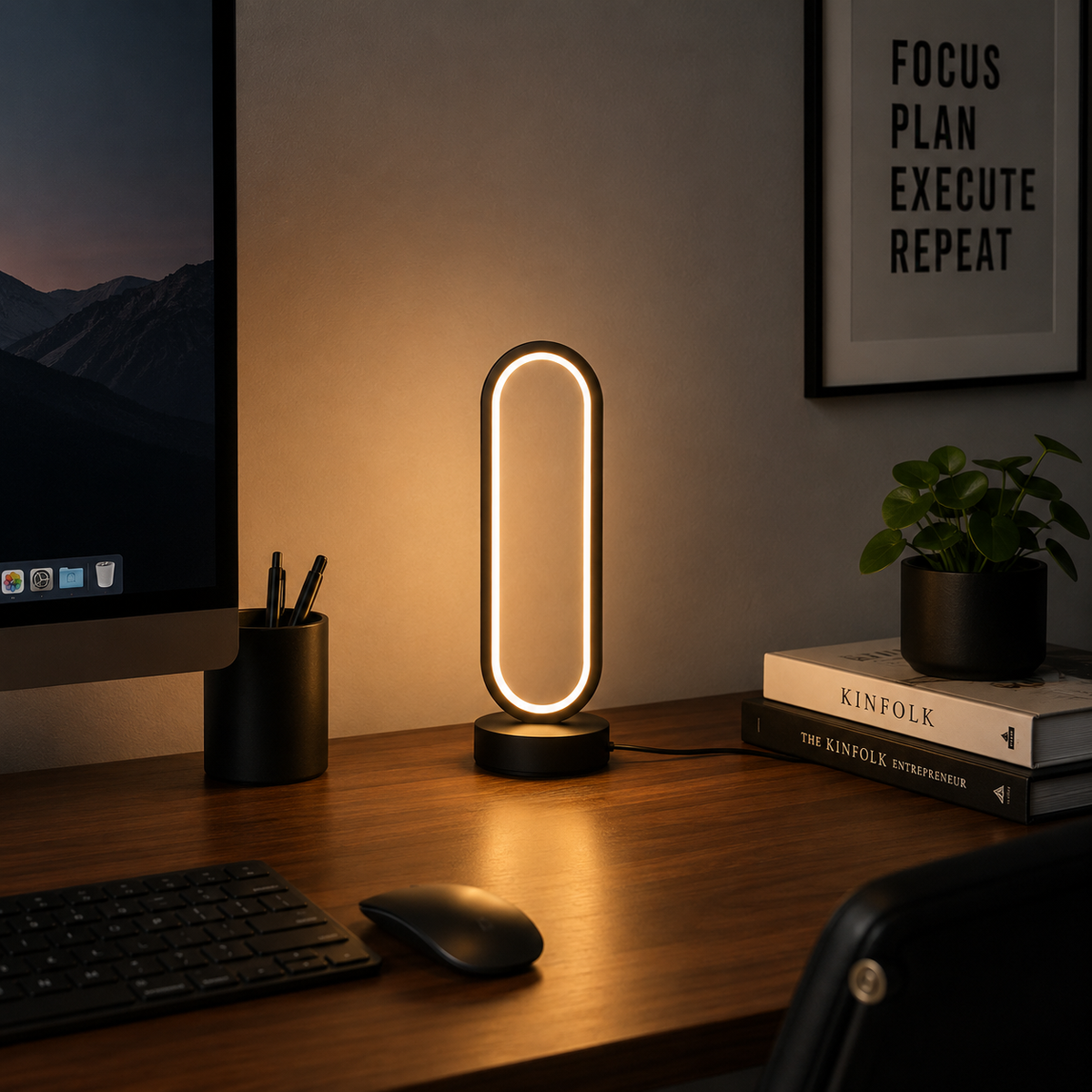 Ring Table Lamp lit on a desk beside a monitor