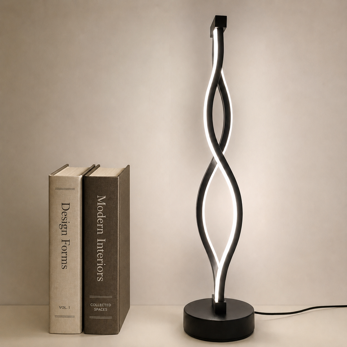 Ribbon Table Lamp in black, lit, beside books