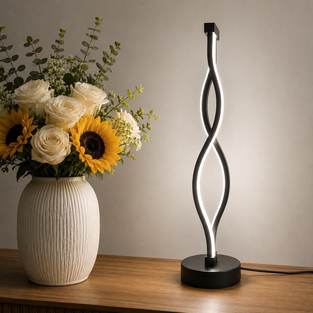 Ribbon Table Lamp lit beside a vase of flowers